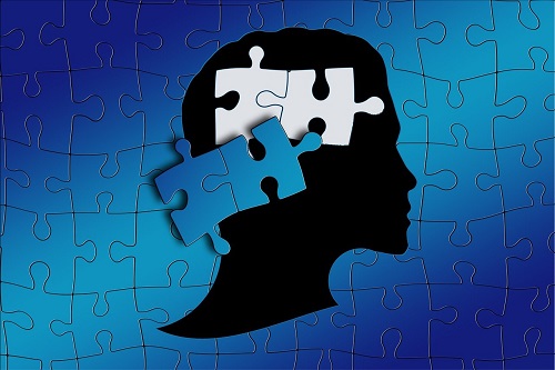silhouette of person with puzzle pieces in brain